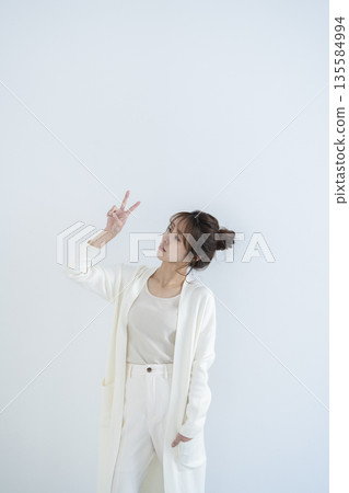 woman doing peace sign 135584994