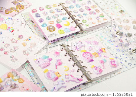 A sticker book filled with lots of stickers A sticker book filled with lots of stickers 135585081