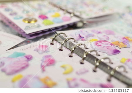 A sticker book filled with lots of stickers A sticker book filled with lots of stickers 135585117