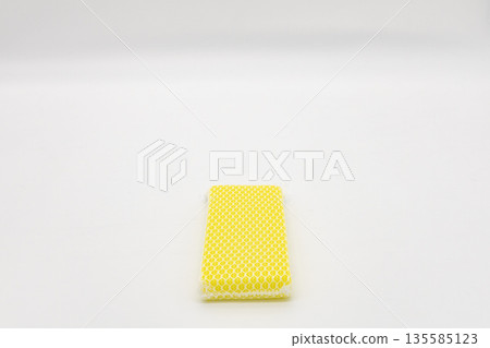 Yellow sponge on white background 135585123