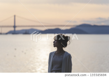 A woman walking along the beach 135585694