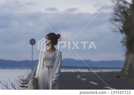 A woman walking along the beach A woman walking along the beach 135585722