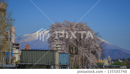 Morioka city overlooking snow-covered Mount Iwaki in Tohoku, Japan. Morioka city overlooking snow-covered Mount Iwaki in Tohoku, Japan. 135585748