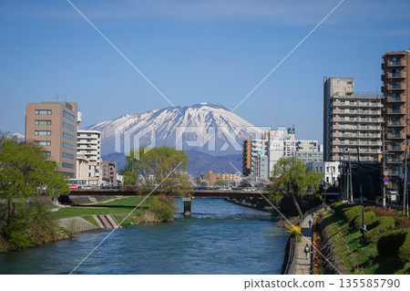 Morioka city overlooking snow-covered Mount Iwaki in Tohoku, Japan. 135585790