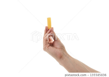 Adult man hand hold dry rigatoni pasta isolated on whit background 135585836