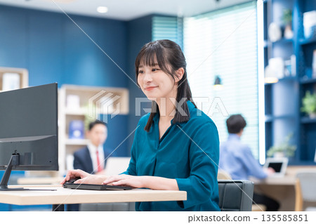 Businesswoman working in the office Businesswoman working in the office 135585851