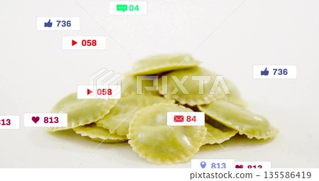 Displaying pile of green ravioli sitting on studio counter, with social media icon overlays Displaying pile of green ravioli sitting on studio counter, with social media icon overlays 135586419
