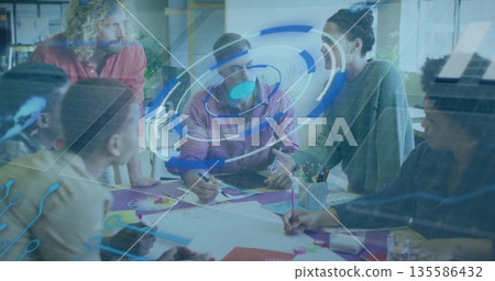 Brainstorming six colleagues leaning over table in office, with sketches, pens, holographic overlay Brainstorming six colleagues leaning over table in office, with sketches, pens, holographic overlay 135586432