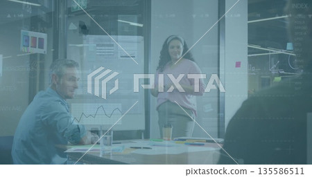 Leading businesswoman in pink sweater discussing charts on whiteboard at meeting table with laptop Leading businesswoman in pink sweater discussing charts on whiteboard at meeting table with laptop 135586511