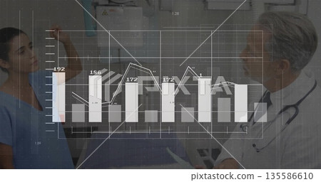 Scrub nurse adjusting overhead X-ray device in radiology with physician using tablet, graph overlay 135586610