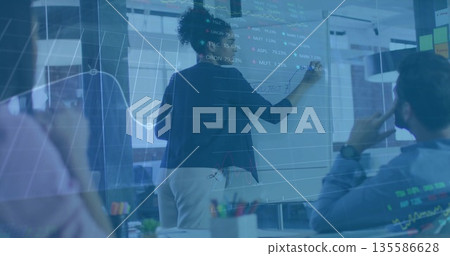 Woman wearing dark blazer marking data on whiteboard in conference room, with marker, chart overlay Woman wearing dark blazer marking data on whiteboard in conference room, with marker, chart overlay 135586628