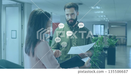 Reviewing documents, office colleagues discussing single sheet and dark folder in open-plan office Reviewing documents, office colleagues discussing single sheet and dark folder in open-plan office 135586687