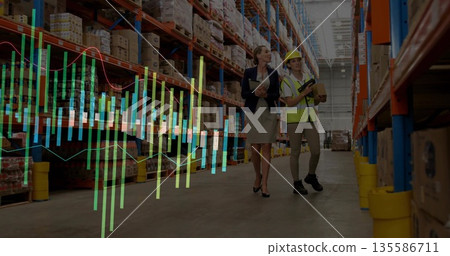 Walking manager and worker viewing data overlay in warehouse aisle, with tablet scanner and package Walking manager and worker viewing data overlay in warehouse aisle, with tablet scanner and package 135586711