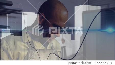Crafting male craftsman shaping metal at metalworking bench, with leather apron and data overlay Crafting male craftsman shaping metal at metalworking bench, with leather apron and data overlay 135586724