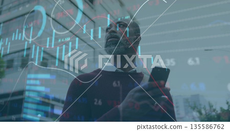 Businessman in sweater holding smartphone gazing skyward in city plaza, floating financial charts Businessman in sweater holding smartphone gazing skyward in city plaza, floating financial charts 135586762