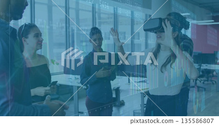 Interacting woman wearing VR headset testing projected interface in office, with phones, copy space Interacting woman wearing VR headset testing projected interface in office, with phones, copy space 135586807