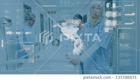 Attending medical team pushing stretcher down hospital corridor, with digital map and stethoscopes 135586835