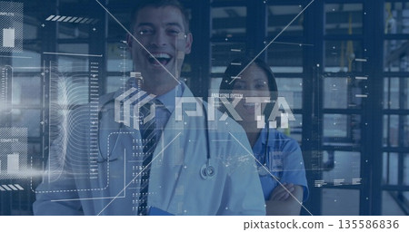 Doctor in lab coat and nurse in scrubs using tablet with stethoscopes, hospital lab HUD graphics 135586836