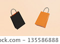 Orange and Black Retail Paper Shopping Bags Mock up. 3D Rendering. 135586888