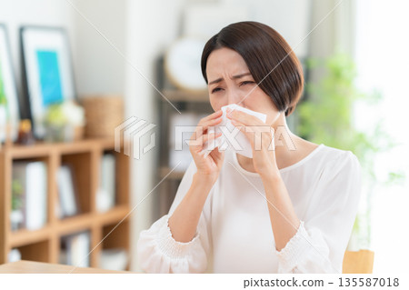 一位中年婦女在客廳擤鼻涕 135587018