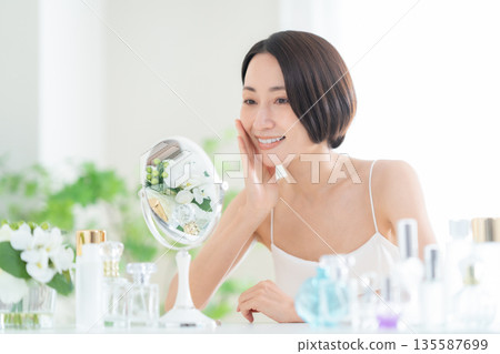 Middle-aged woman doing skin care Middle-aged woman doing skin care 135587699
