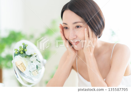 Middle-aged woman doing skin care Middle-aged woman doing skin care 135587705