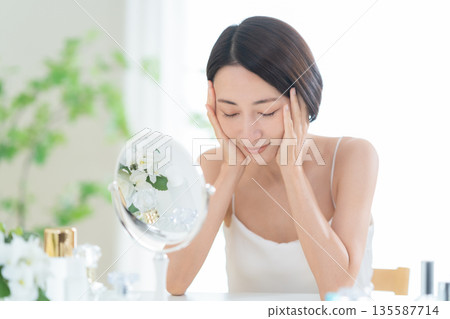 Middle-aged woman doing skin care Middle-aged woman doing skin care 135587714