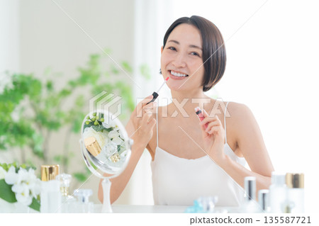 Middle-aged woman doing skin care Middle-aged woman doing skin care 135587721
