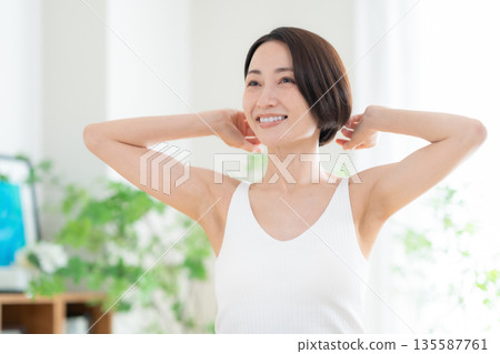 Middle-aged woman doing skin care 135587761