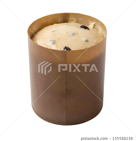 Unbaked panettone dough sitting in its classic paper mold, ready for the oven. Perfect for christmas baking, italian cuisine, and food preparation 135588238