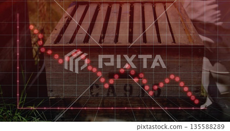 Handling wooden box while kneeling in grassy backyard, displaying 3D grid and red dotted graph Handling wooden box while kneeling in grassy backyard, displaying 3D grid and red dotted graph 135588289
