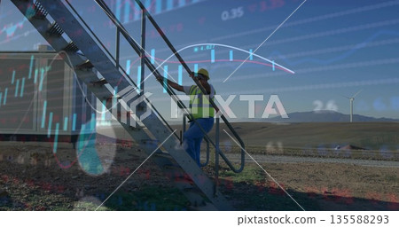 Field technician wearing yellow hard hat, vest climbing stairs in wind farm, with financial overlay Field technician wearing yellow hard hat, vest climbing stairs in wind farm, with financial overlay 135588293