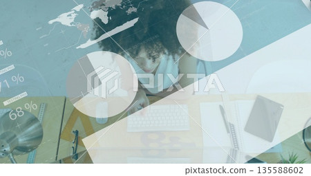 Leaning woman with curly hair analyzing data overlays at home office, with keyboard and mouse Leaning woman with curly hair analyzing data overlays at home office, with keyboard and mouse 135588602