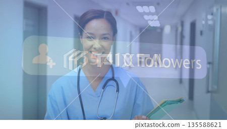 Smiling nurse wearing stethoscope holding patient folders in hospital, overlaying 455,410 followers Smiling nurse wearing stethoscope holding patient folders in hospital, overlaying 455,410 followers 135588621