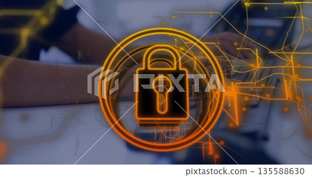 Typing woman in dark top securing data at home desk, with glowing orange padlock overlay Typing woman in dark top securing data at home desk, with glowing orange padlock overlay 135588630