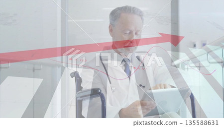 Senior doctor in white coat analyzing tablet data in hospital hall with wheelchair and stethoscope Senior doctor in white coat analyzing tablet data in hospital hall with wheelchair and stethoscope 135588631