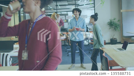 Holding red coffee mug, Hispanic man wearing blue shirt in open-plan office, with sticky notes Holding red coffee mug, Hispanic man wearing blue shirt in open-plan office, with sticky notes 135588731