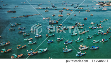 Fishing boats, coastal harbor, turquoise water, aerial view 135588881