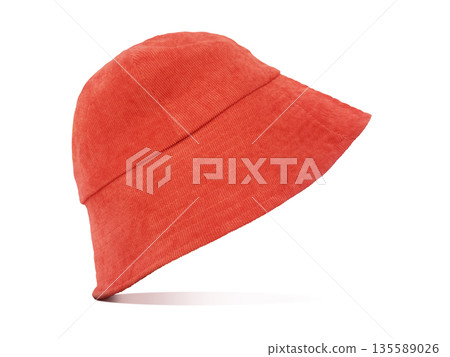An orange velvet bucket hat is stylishly placed against a white background. An orange velvet bucket hat is stylishly placed against a white background. 135589026
