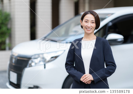 A middle-aged businesswoman working in a car A middle-aged businesswoman working in a car 135589178