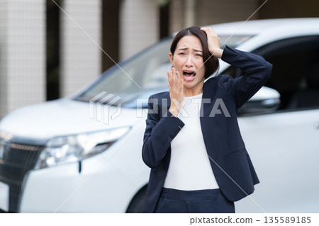 A middle-aged businesswoman working in a car A middle-aged businesswoman working in a car 135589185