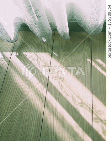 Sunlight filtering through lace curtains 2 135589354