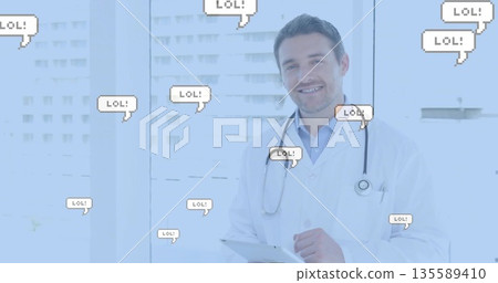 Doctor checking tablet messages at clinic with LOL bubbles, in lab coat and stethoscope, copy space 135589410