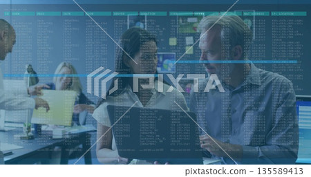 Collaborating mature woman and man analyzing code on laptop at modern operations center, dashboards 135589413