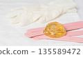 Waxing supplies on a table with wooden sticks and wax ready for use in a hair removal session 135589472