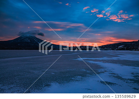 Winter flowers blooming on the ice field - Lake Akan at sunrise Winter flowers blooming on the ice field - Lake Akan at sunrise 135589629
