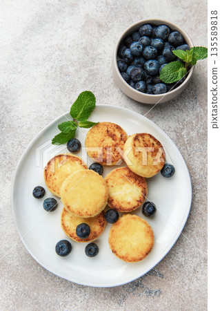 Syrniki cottage cheese pancakes with blueberries and mint Syrniki cottage cheese pancakes with blueberries and mint 135589818
