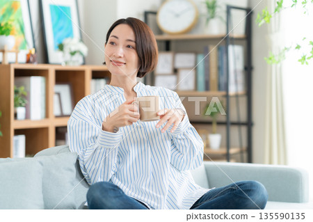中年婦女在客廳的沙發上放鬆 135590135