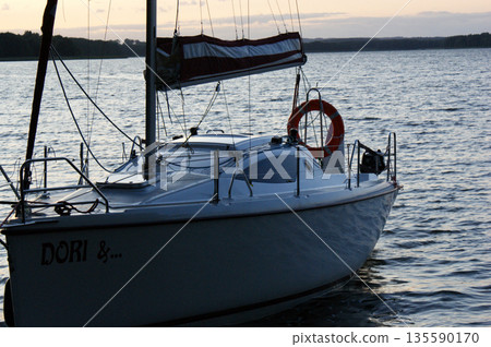 sunset sailing yacht sailboat moored on a dead lake sunset sailing yacht sailboat moored on a dead lake 135590170