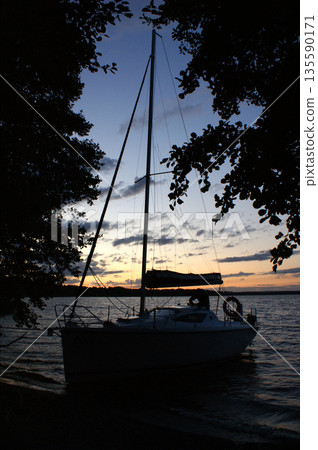 sunset sailing yacht sailboat moored on a dead lake sunset sailing yacht sailboat moored on a dead lake 135590171